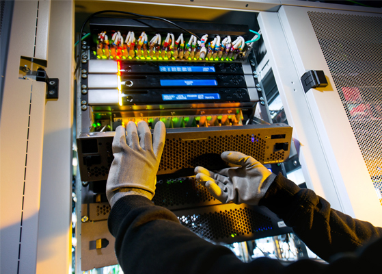 Electrician servicing equipment in a data center facility