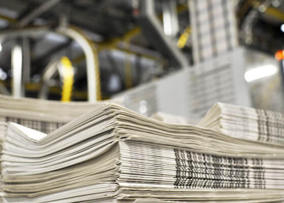 Pile of stacked newspapers at the NY Times production plant