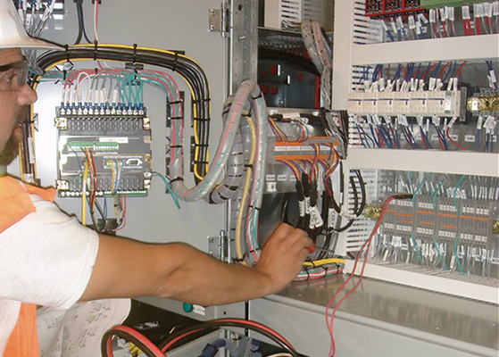 FENJ technician looking at electrical wires