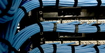 Close up view of a custom structured cabling project with blue cables